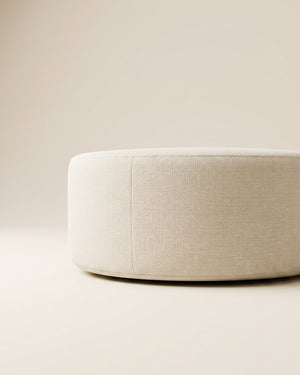 Supellex Home pouf redondo bajo Luna tapizado en tela texturizada color beige - vista en perspectiva de detalle