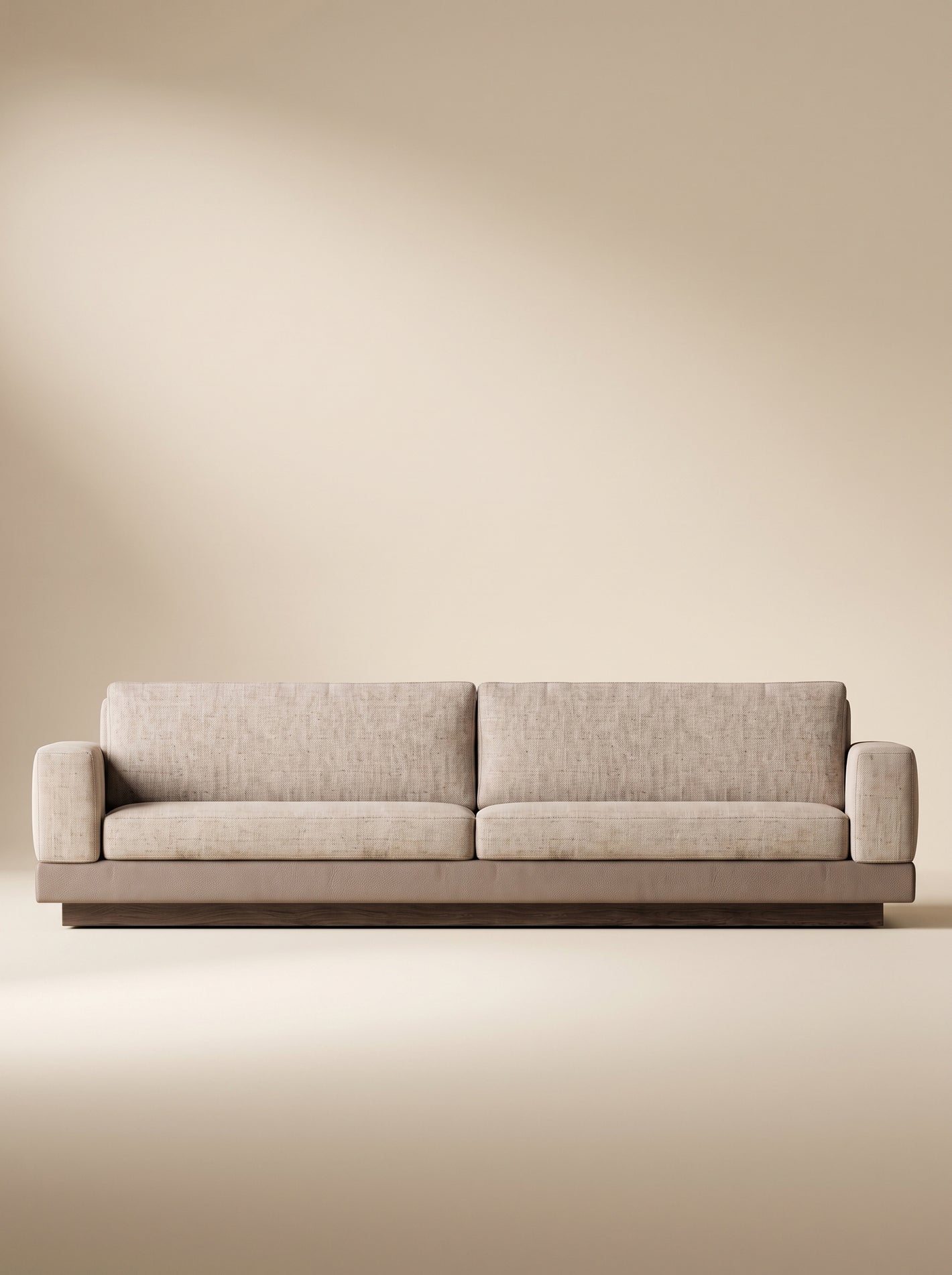 Sofá lineal de tres puestos Bali tapizado en tela texturizada beige con base inferior combinada en tono taupe y zócalo de madera natural.