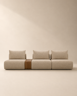 Sofá modular Sepia tapizado en tela de lino beige con mesa auxiliar integrada de madera natural y diseño minimalista a ras de suelo.